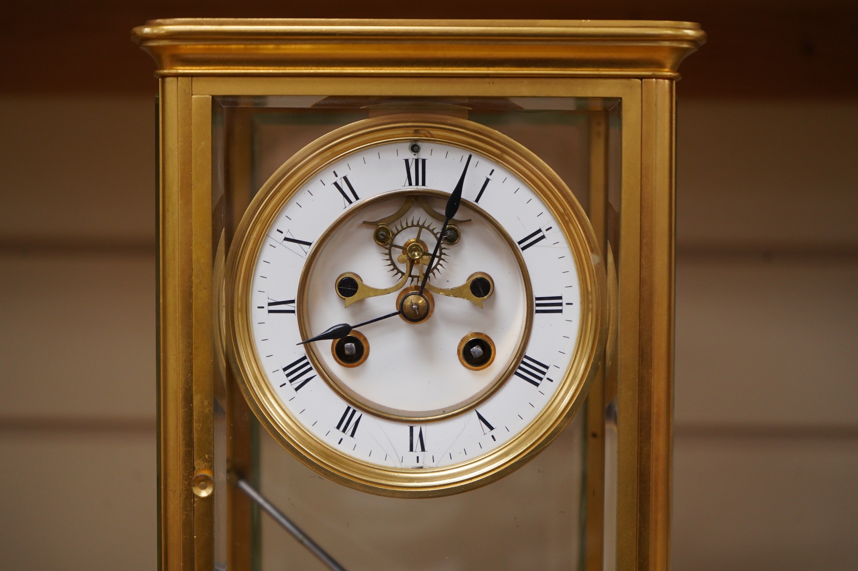 A late 19th century French gilt brass four glass clock, with visible Brocot escapement, key and pendulum, 29.5cm tall. Condition - fair, cracks to dial, not tested